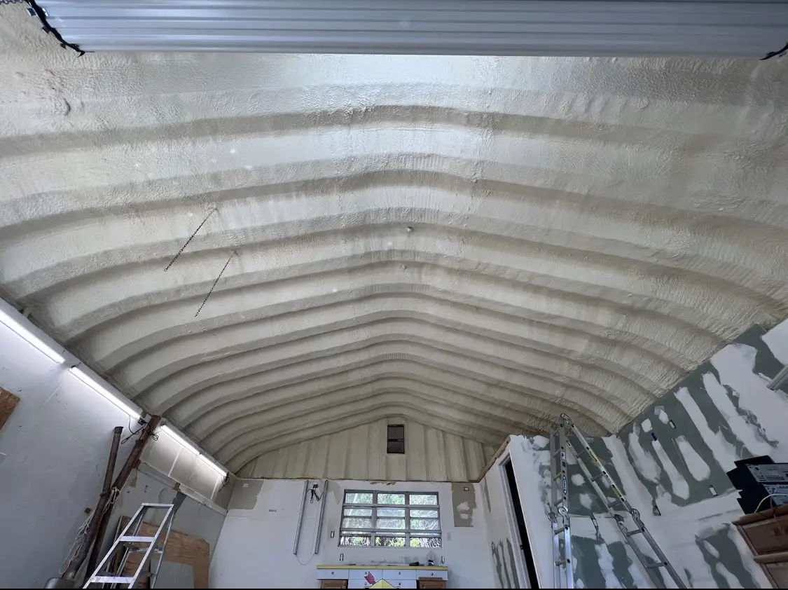 Spray polyurethane foam applied to the underside of a metal roof deck in Penitas